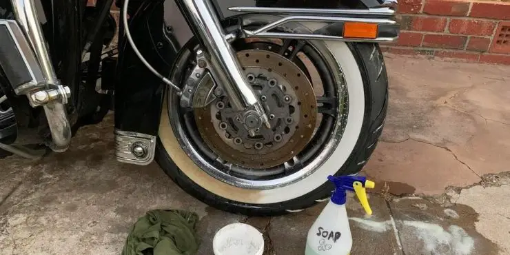 cleaning white wall tires on a motorcycle
