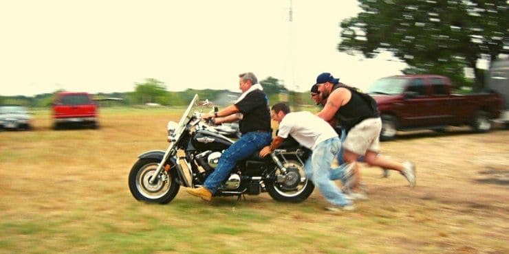 Group Of Men Pushing Harley Davidson Bike To Start