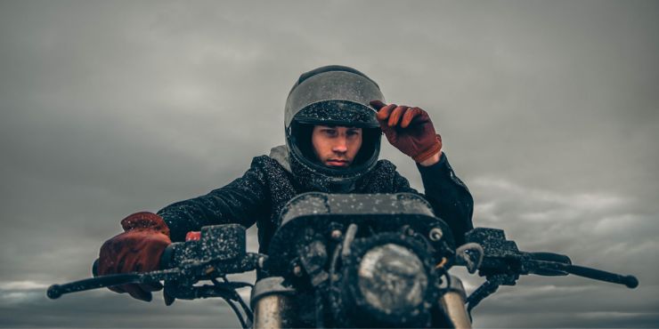 Man Riding A Motorcycle In Winter