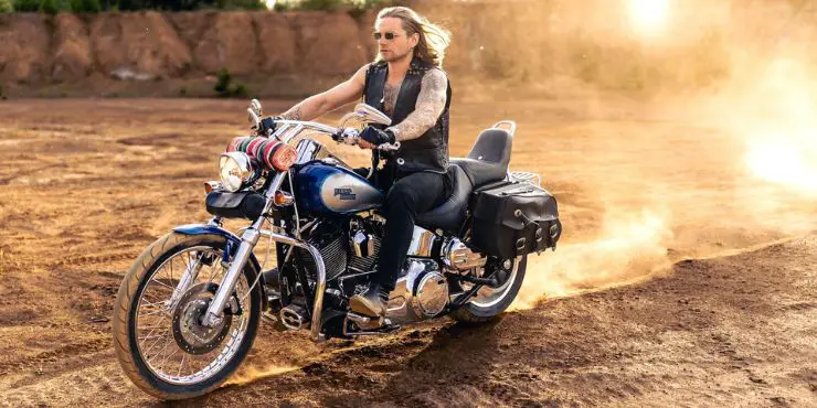 how fast is a harley davidson - cool harley rider in dirt road
