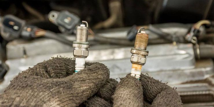 person holding harley davidson spark plugs