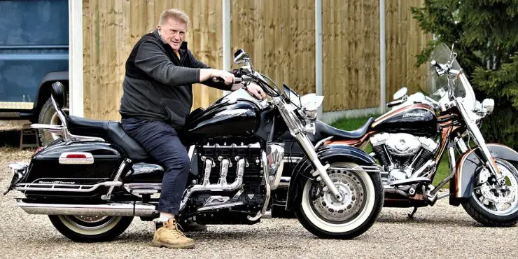 A happy man taking a ride pose on his rented Harley-Davidson motorcycle