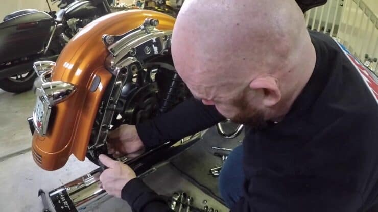 How To Install Hard Saddlebags On A Softail - Man Working On A Harley Davidson