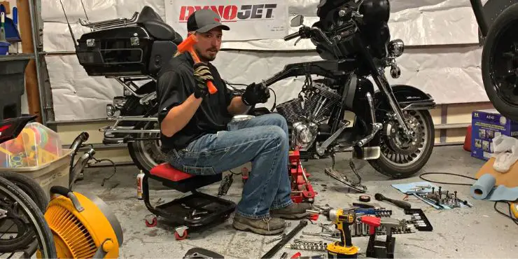 Person Checking Fuel Pressure Of Harley Davidson Motorcycle