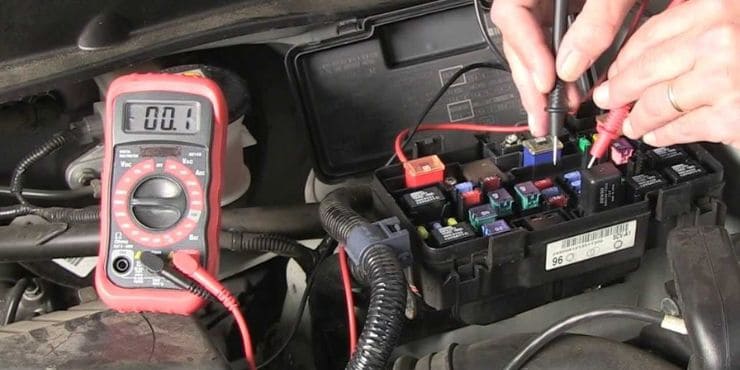 Person Using Harley Voltage Regulator In Checking Motorcycle Engine
