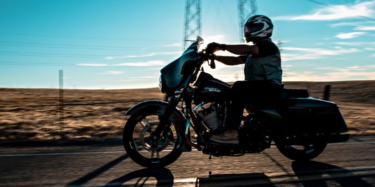 Professional Rider Driving Harley-Davidson Motorcycle On The Road