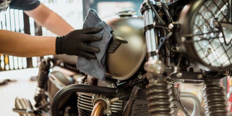 Person Wiping Harley-Davidson Bike With Towel