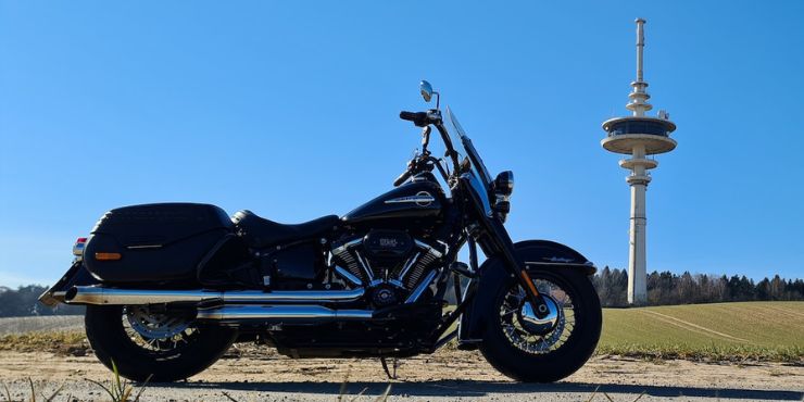 Parked Harley-Davidson Softail With A Tower In The Background