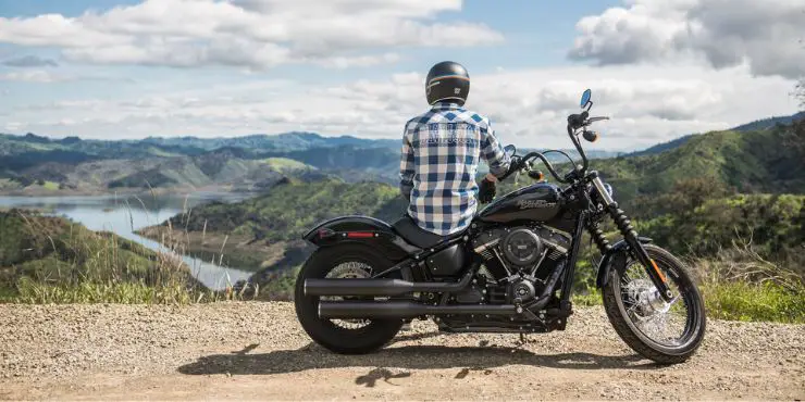 When Is It Too Windy To Ride A Motorcycle - Man Sitting On His Motorcycle Relaxing While Looking At The View From The Hilltop