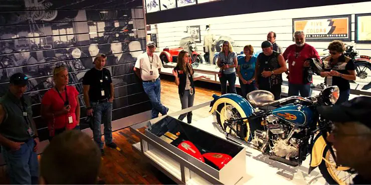 A Tour Guide Explaining On Visitors Inside The Harley-Davidson Museum