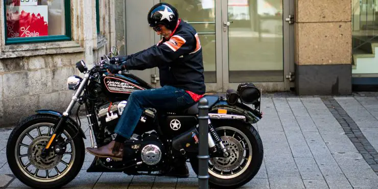 Professional Biker Wearing Harley Davidson Jacket While Riding In Motorcycle